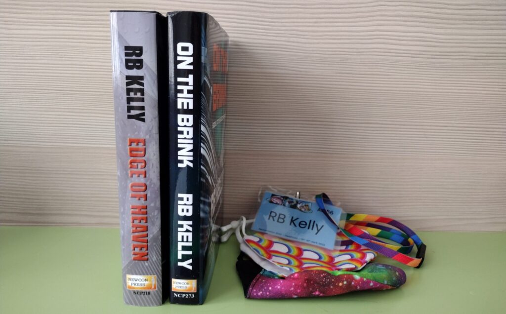 On the Brink and Edge of Heaven by RB Kelly sitting side by side on a shelf