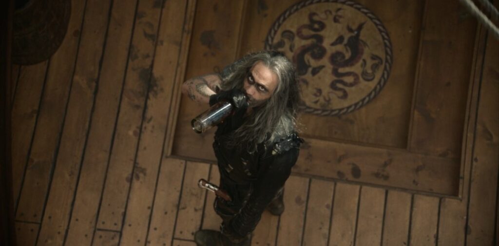 Blackbeard in Kraken get up glares up from the deck of the Revenge
