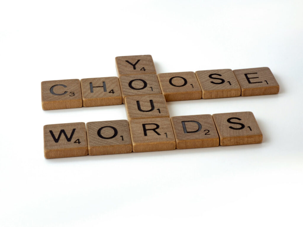 scrabble tiles spelling out CHOOSE YOUR WORDS