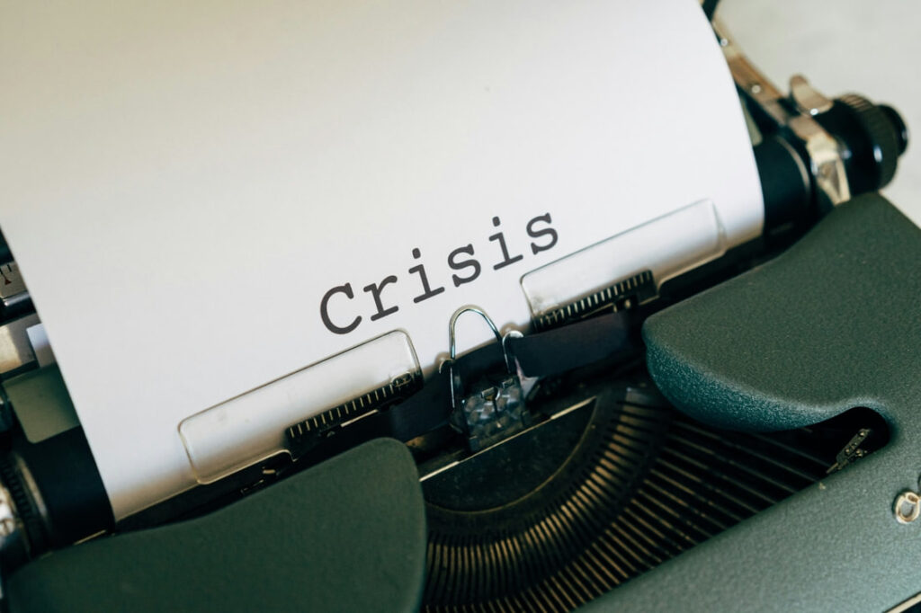 Typewriter with the word CRISIS on a page
