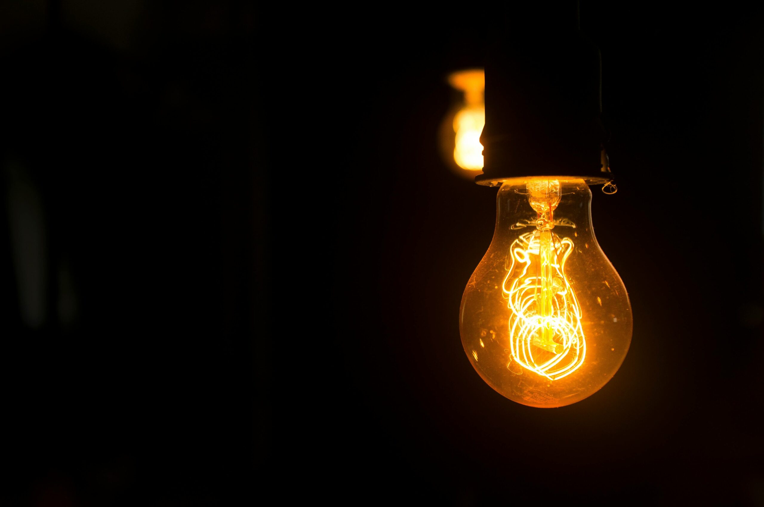 Bare lightbulb in a dark room
