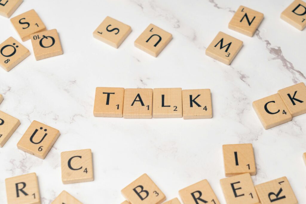 scrabble tiles spelling out the word TALK