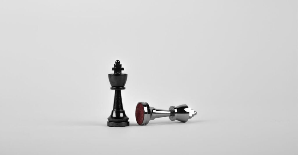 Two Silver Chess Pieces on White Surface