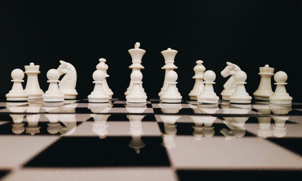 white chess pieces against a black background