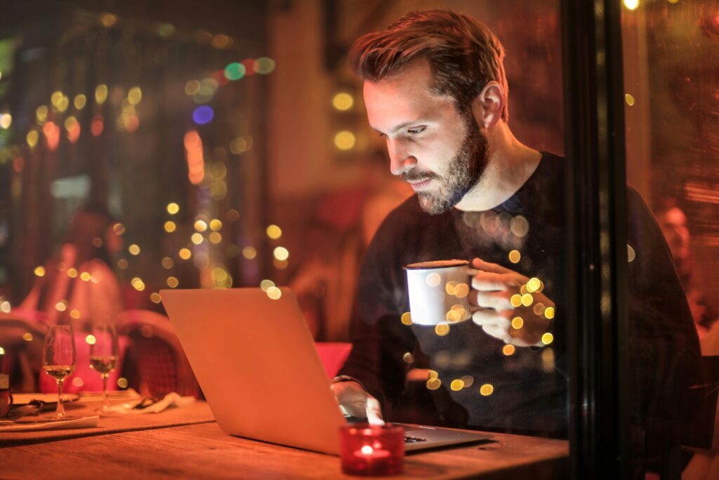 author writing at a laptop in a sparkly cafe