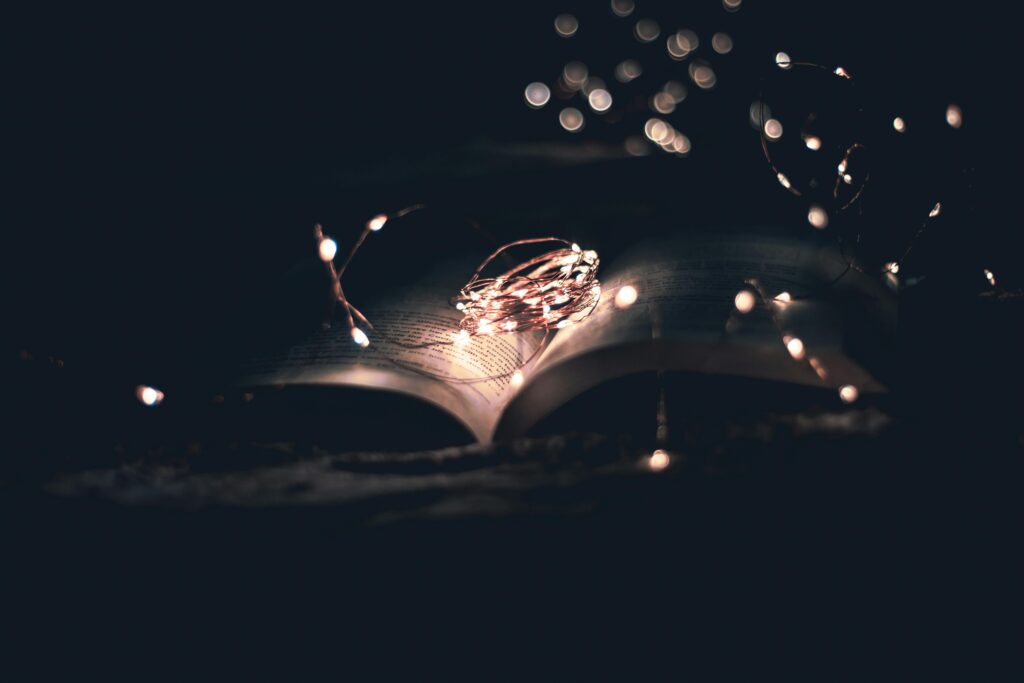 an open book illuminated by fairy lights representing the narrative magic that happens when your story uses both visible and invisible narratives