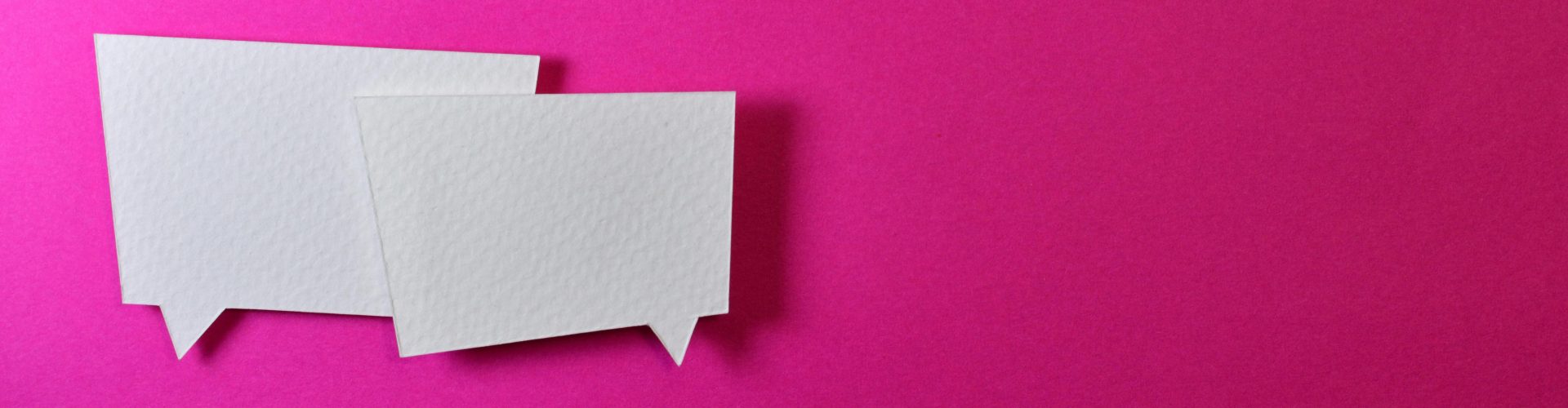 two white dialogue boxes against a hot pink background
